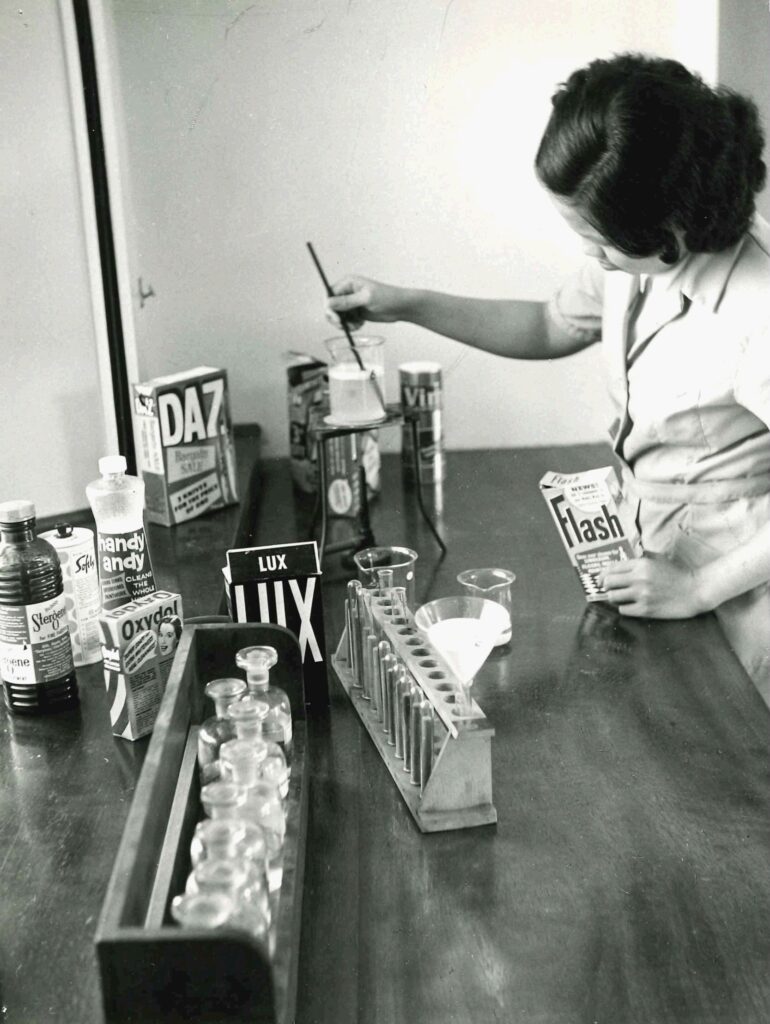 Student at Bath College of Domestic Science conducting a water hardness test as part of a laundry class, 1950s